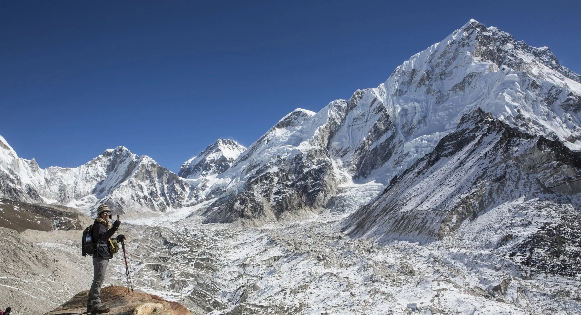 Trekker standing before vast Himalayan glacier panorama in Nepal